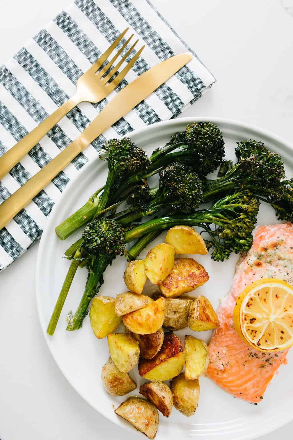 sheet pan salmon dinner on a white plate