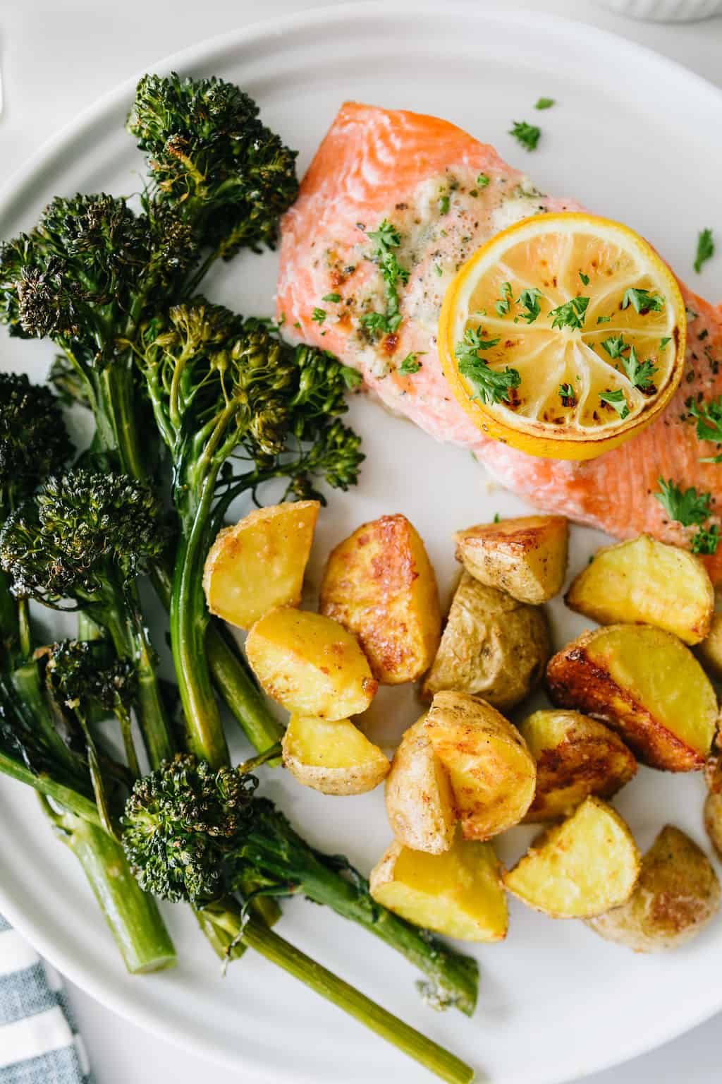 sheet pan salmon dinner on white plate