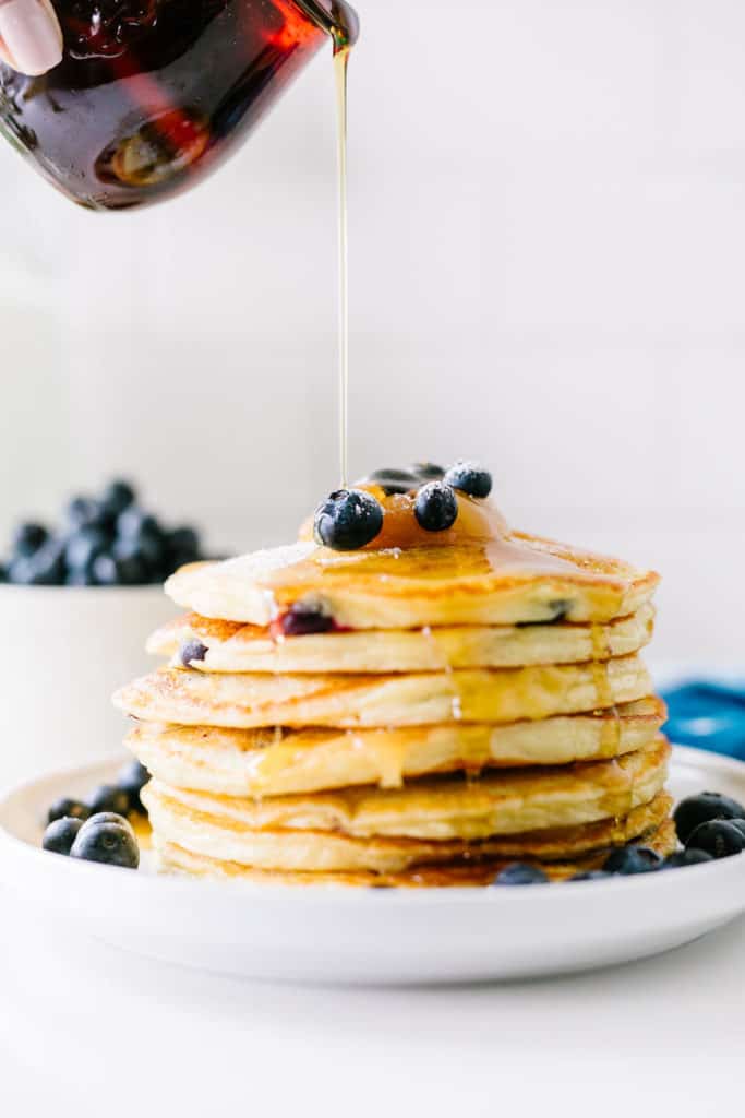 Gluten-Free Lemon Blueberry Buttermilk Pancakes syrup pour