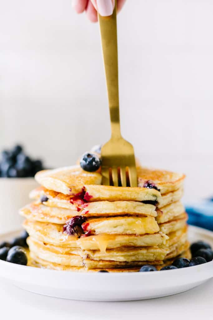 Gluten-Free Lemon Blueberry Buttermilk Pancakes fluffy short stack with fork ready to eat