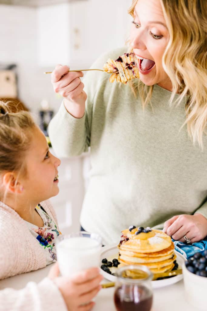 Gluten-Free Lemon Blueberry Buttermilk Pancakes taking a big bite