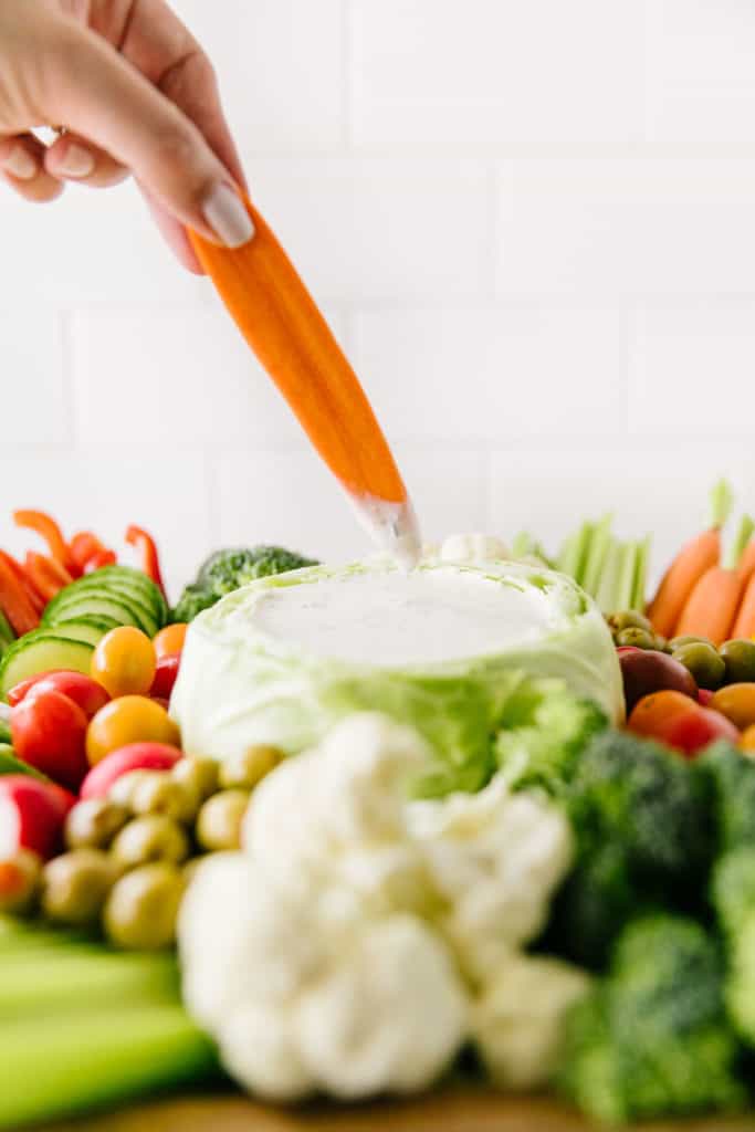 The Best Homemade Ranch Dressing- carrot dipping into dressing bowl
