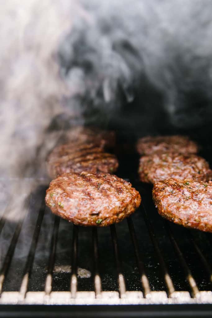 Mediterranean lamb burgers on the grill with smoke 