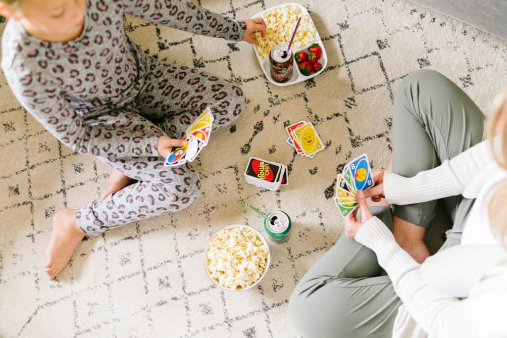 Family night without all the sugar- mom and daughter playing a card game with treats