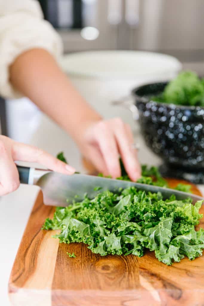 The Best Kale Salad chopping kale with a knife 